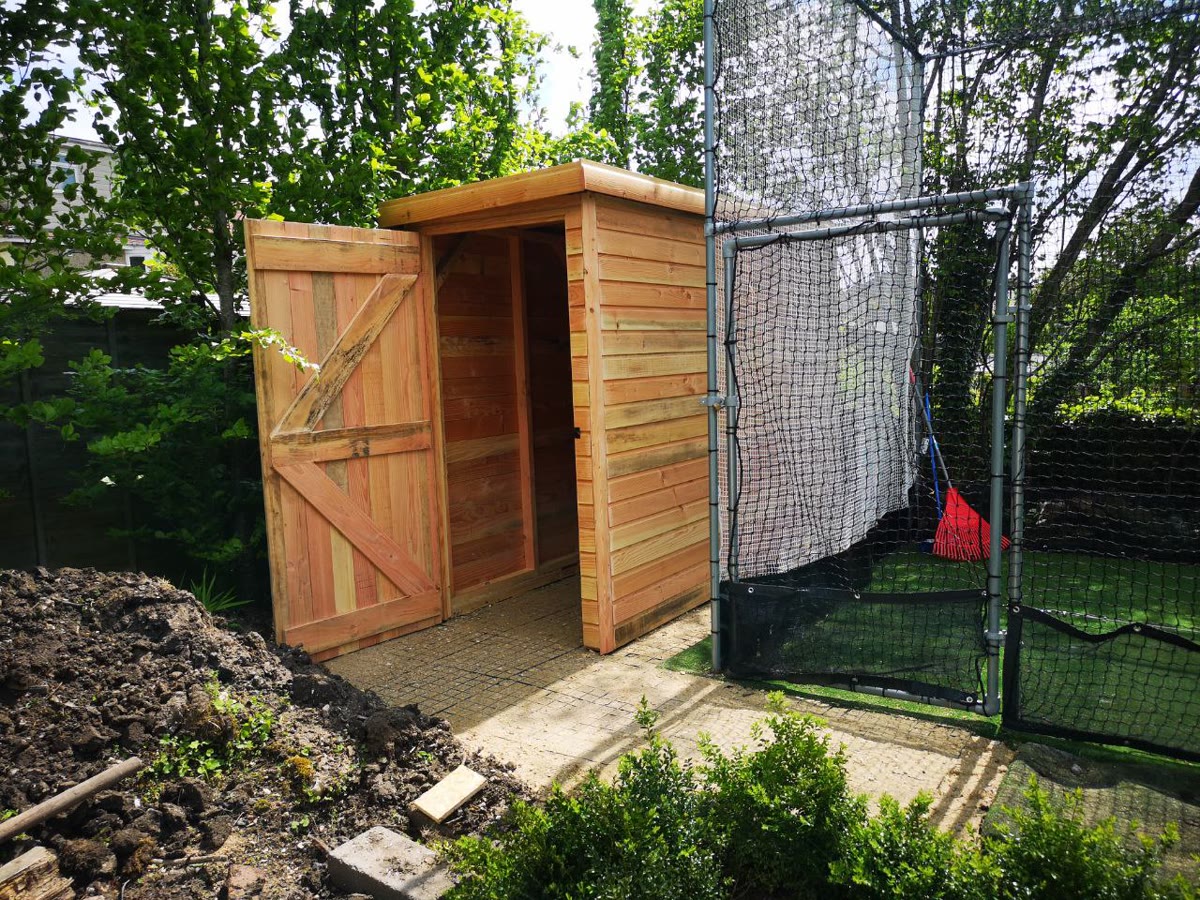 Compact pent roof tool store with ledge and brace door